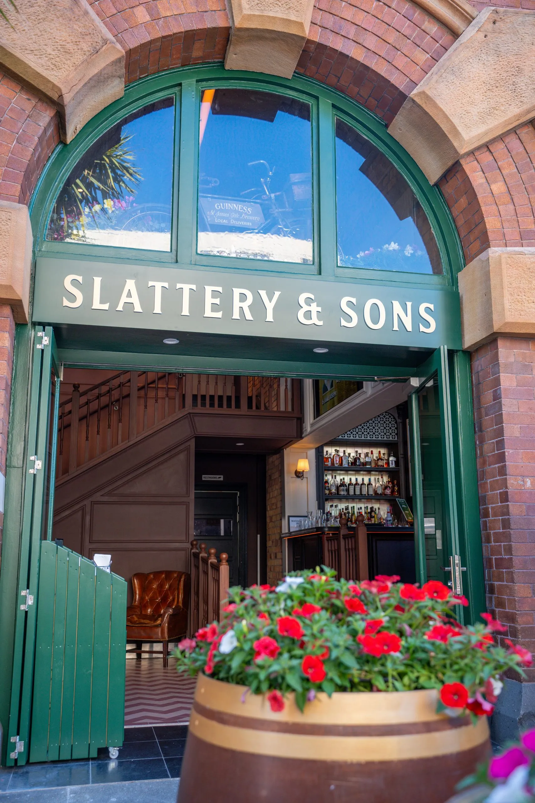 Brick entrance with Slattery and Sons signage. Shown as location context. ERC delivered the strip-out, not this later fitout.