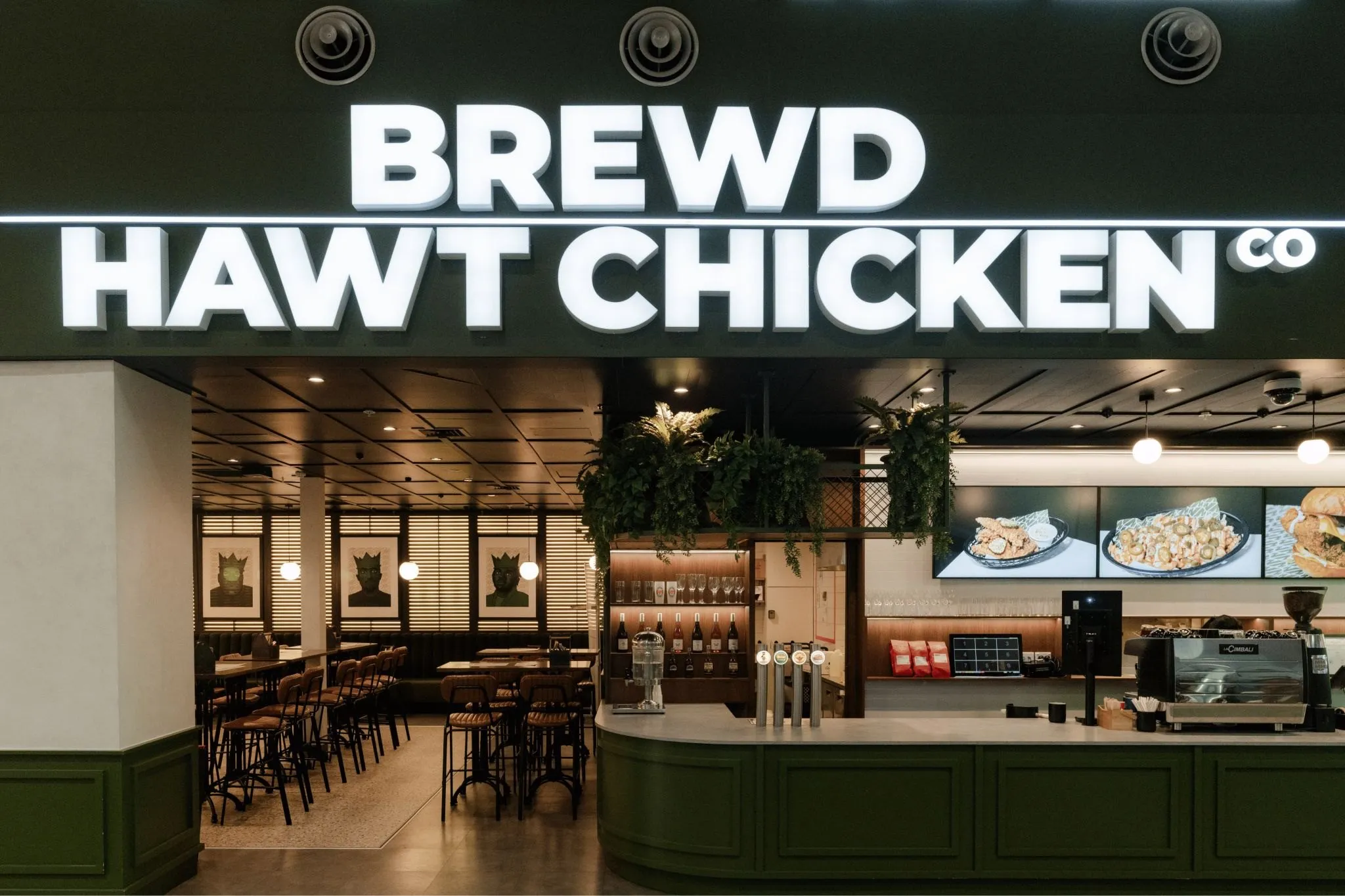 Completed Brew’d Hawt Chicken storefront with dark green joinery and illuminated signage.