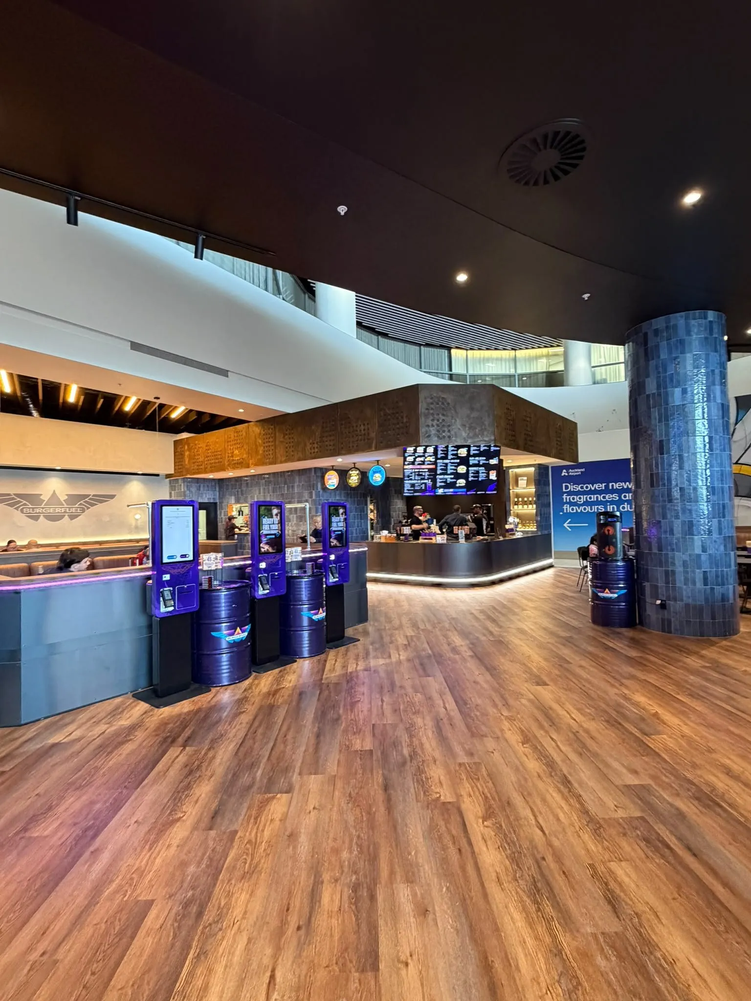 Completed BurgerFuel tenancy with order kiosks, the service counter and timber flooring.