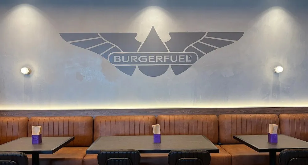 Dining booths beneath a BurgerFuel wall logo.