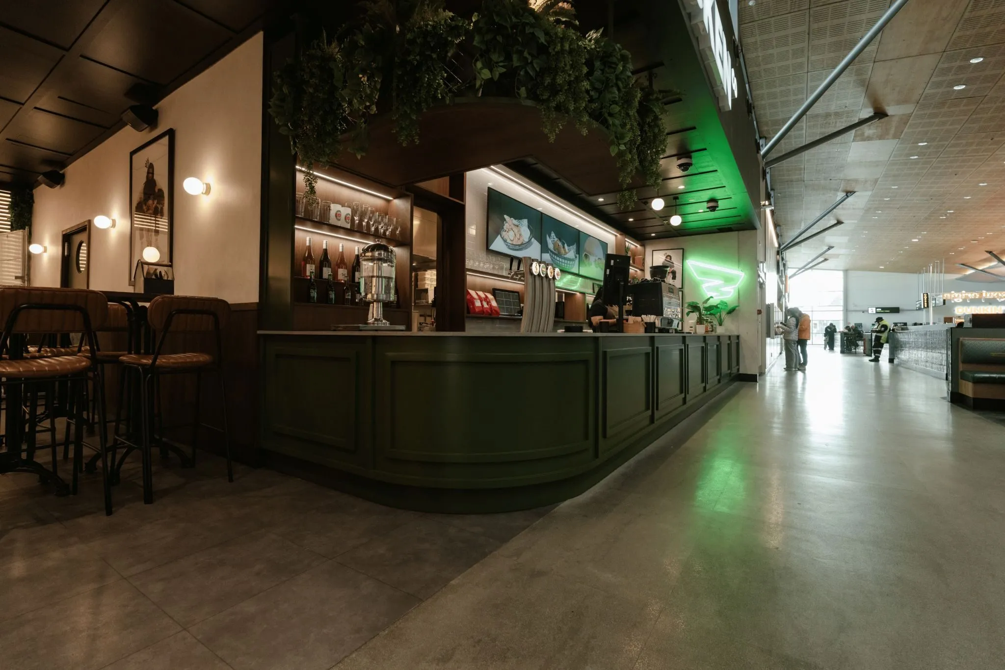 Service counter at Brew’d Hawt Chicken, with dark green joinery, stools and the pass along the front.